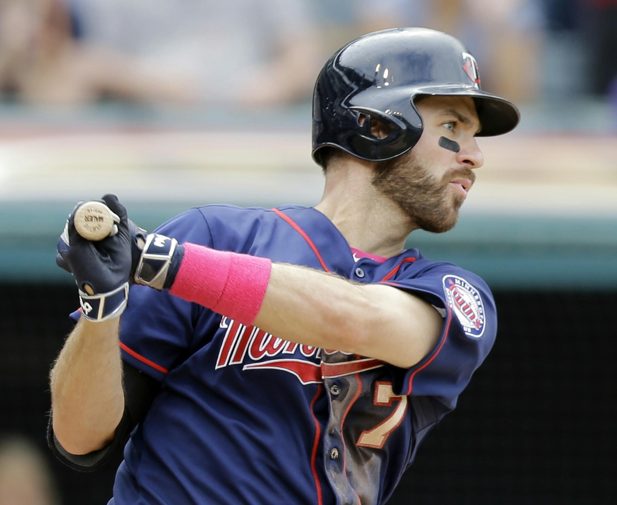 Minnesota Twins' Joe Mauer hits an RBI-single off Cleveland Indians relief pitcher Cody Allen in the ninth inning of a baseball game, Sunday, May 10, 2015, in Cleveland. Torii Hunter scored on the play. The Indians defeated the Twins 8-2. (AP Photo/Tony Dejak)