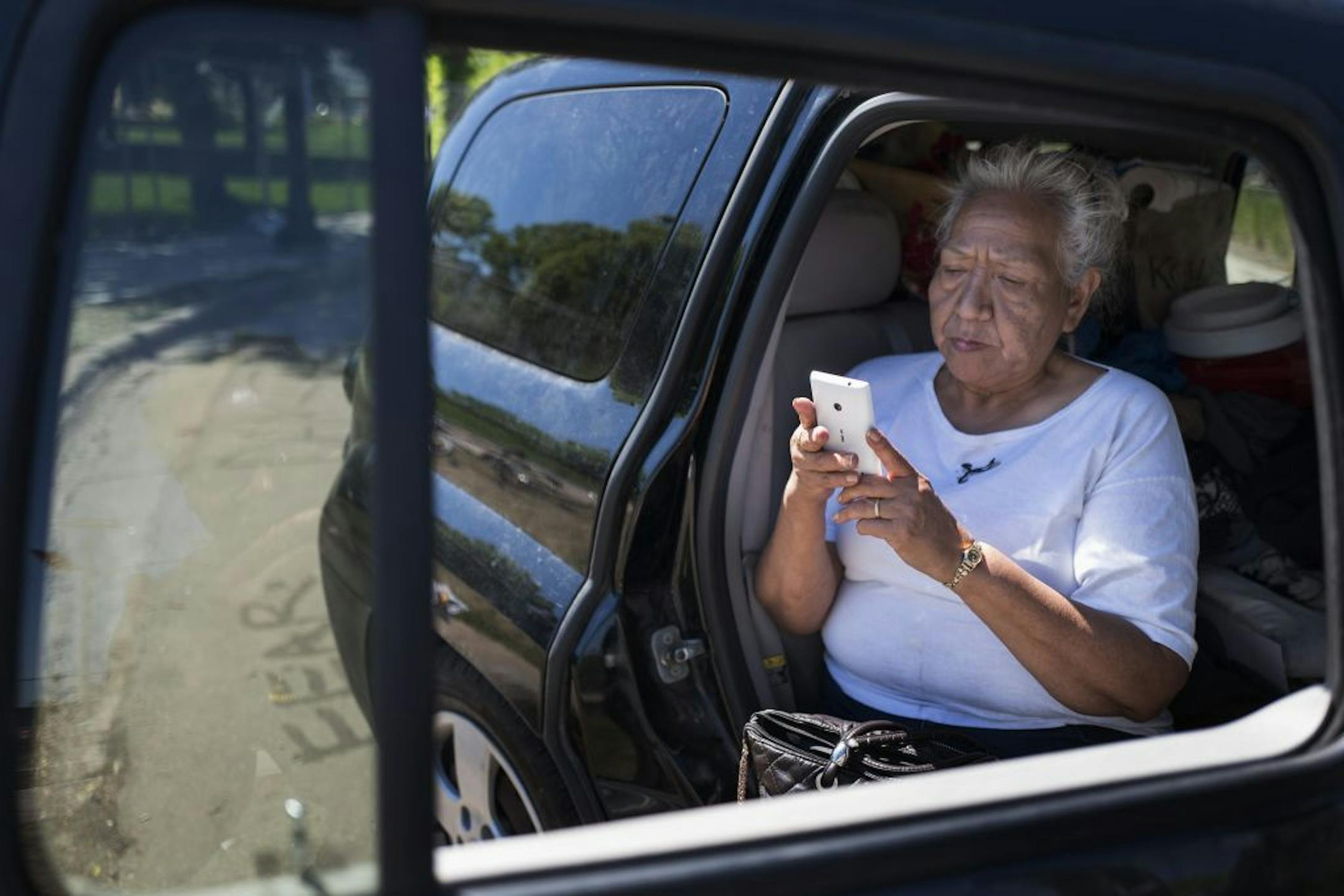 Geraldine Cole saved photos on her phone Monday, June 5, after taking pictures of the site where protests were held against the "Scaffold" sculpture at the Walker Art Center in Minneapolis.