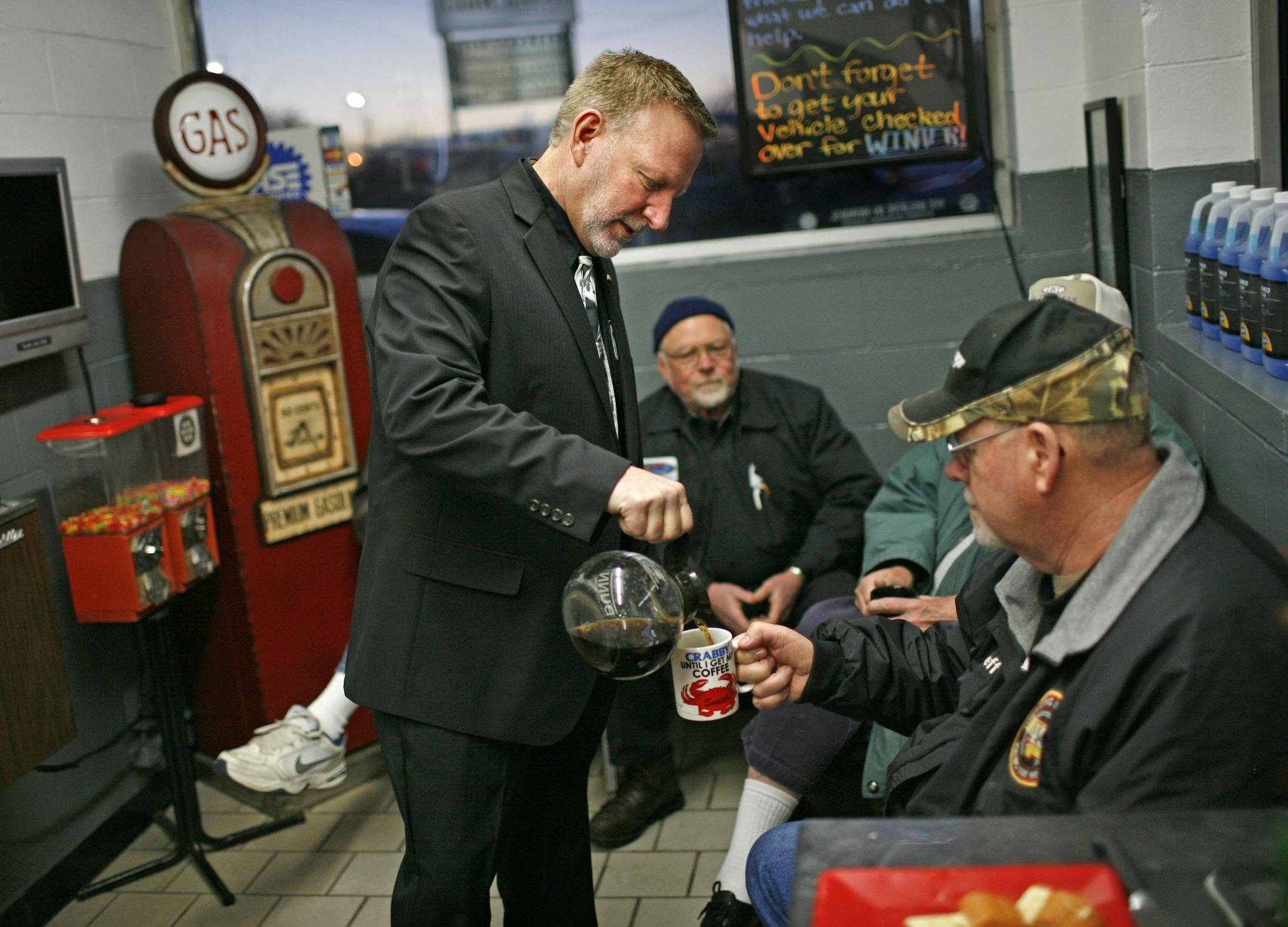 At little past 7:30 a.m., station owner Scott Schulte makes the rounds with the coffee pot, pouring for Jeff LePage, one of many pots brewed this morning. Later this day, Schulte will go off to his other job as an Anoka county commissioner. ] Scott Schulte's Hi Ten Service Station in Coon Rapids doesn't open until 6 a.m., but he's up at 3 each morning and has coffee brewing at the shop by 4:30 for a group of dedicated customers, characters and employees who often arrive before dawn. It's somethi