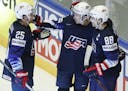 Johnny Gaudreau, center, of the United States celebrates with teammates Patrick Kane, right, and Blake Coleman, left, after scoring a goal during the 