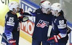 Johnny Gaudreau, center, of the United States celebrates with teammates Patrick Kane, right, and Blake Coleman, left, after scoring a goal during the 