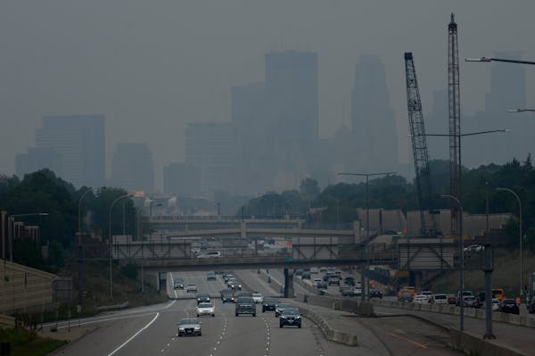 Traffic moved along the I-35W on Friday, with downtown Minneapolis enveloped by a smoky haze, as seen from the E. 46th Street overpass.