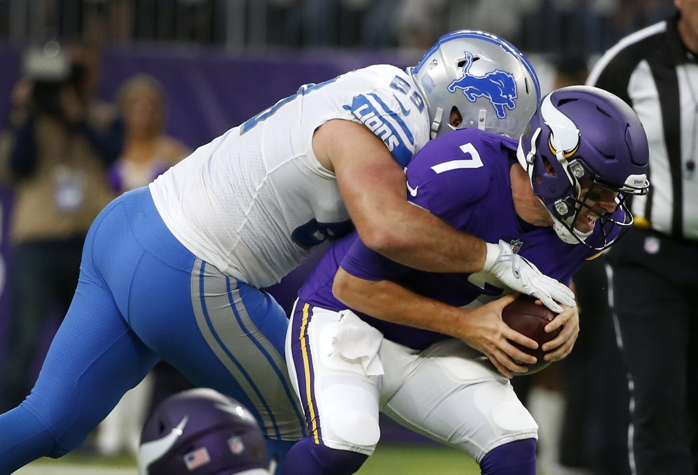 Minnesota Vikings quarterback Case Keenum (7) is sacked by Detroit Lions defensive end Anthony Zettel, left, during the first half of an NFL football game, Sunday, Oct. 1, 2017, in Minneapolis. (AP Photo/Bruce Kluckhohn)