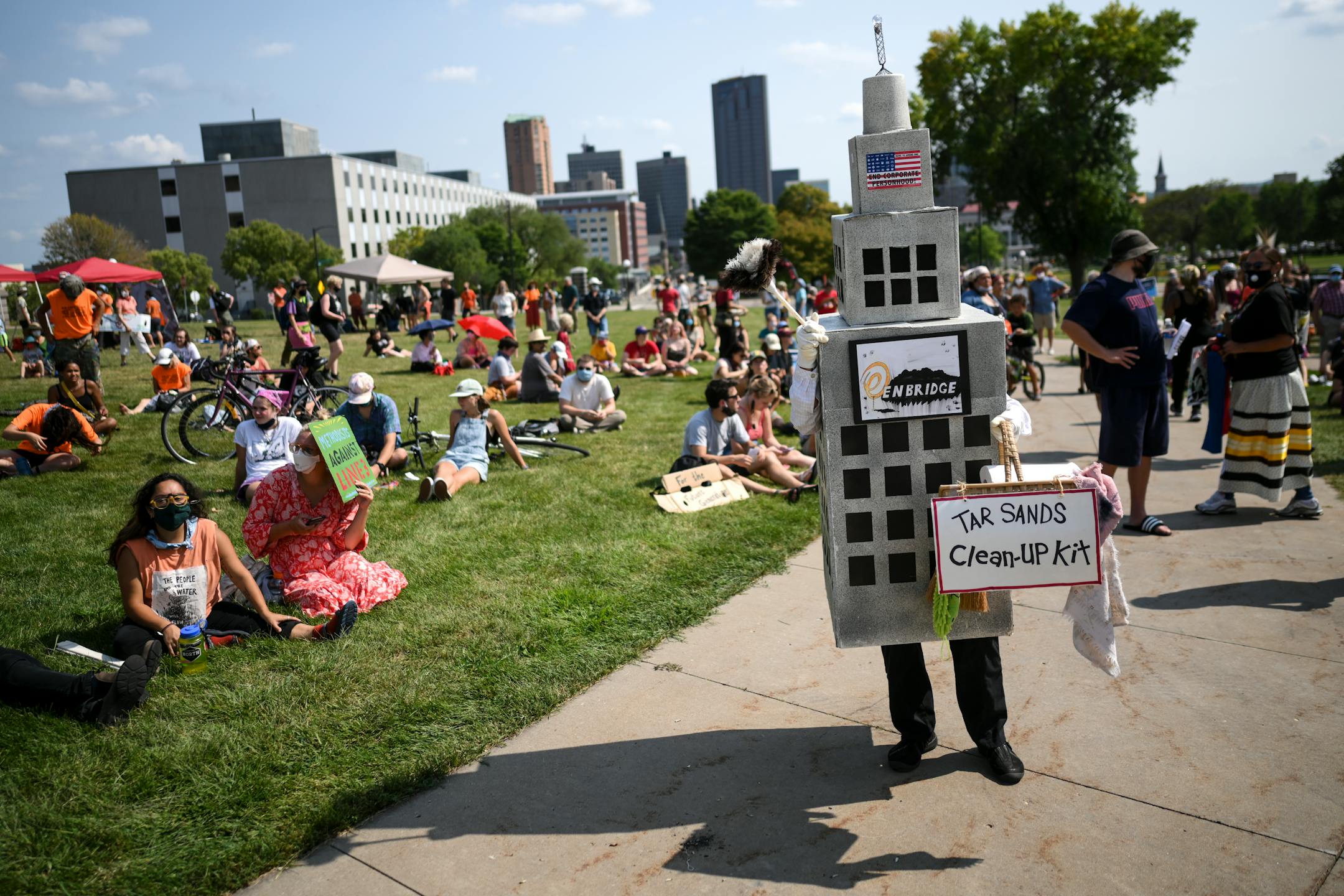 A protester, wearing an Enbridge skyscraper costume with a 'Tar Sands Cleanup Kit' made their way throughout the capitol mall Wednesday.