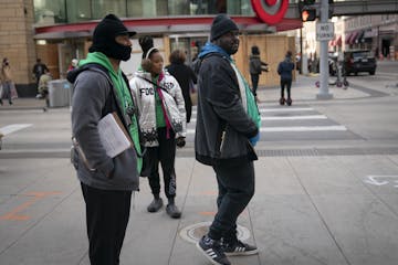 MAD DADS outreach workers Marko Counters, Kay Jones and Ken Bryant mingled with people Friday amid boarded-up buildings on Nicollet Mall.