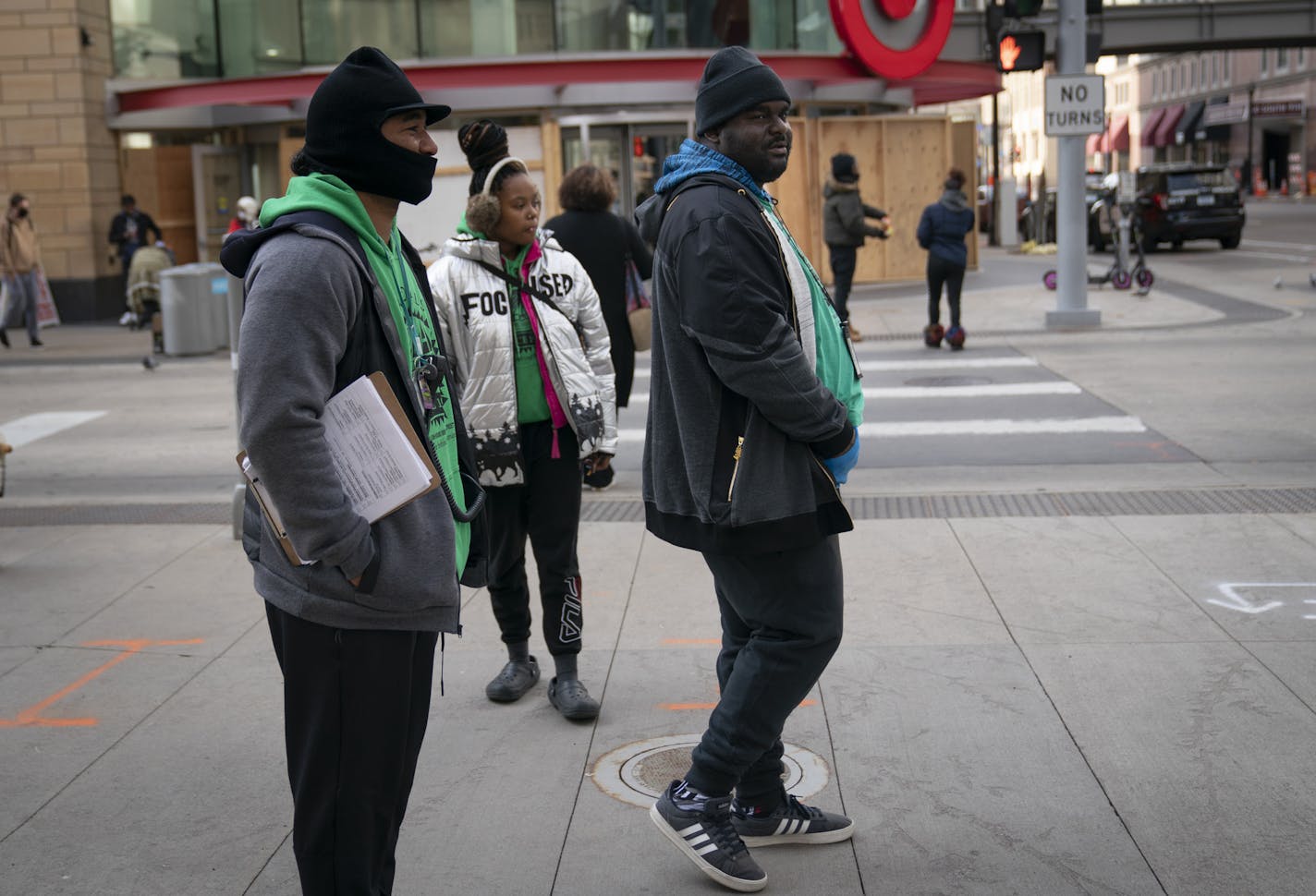 MAD DADS outreach workers Marko Counters, Kay Jones and Ken Bryant mingled with people Friday amid boarded-up buildings on Nicollet Mall.