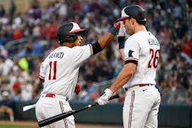 Minnesota Twins' Jorge Polanco (11) celebrates with Max Kepler (26) after hitting a home run against the Texas Rangers during the sixth inning of a ba