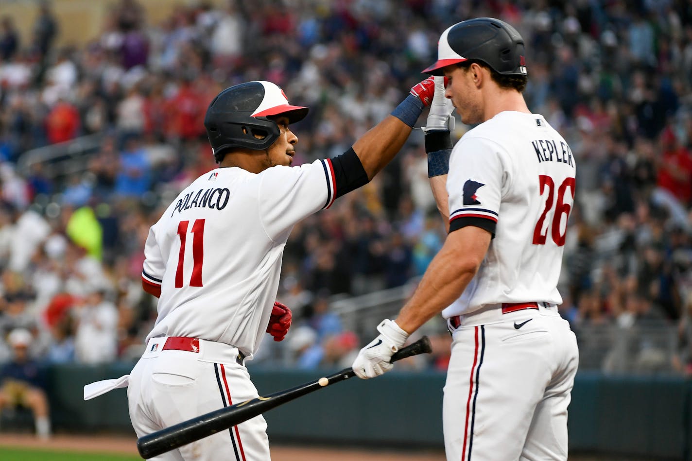 Minnesota Twins' Jorge Polanco (11) celebrates with Max Kepler (26) after hitting a home run against the Texas Rangers during the sixth inning of a baseball game Saturday, Aug. 26, 2023, in Minneapolis. The Rangers won 6-2. (AP Photo/Craig Lassig)