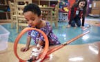 Child Life volunteer Yesica Mercado Munoz, 16, played with 2-year-old Damian Bridges, who was hospitalized for hypoglycemia at Children's Hospital in 