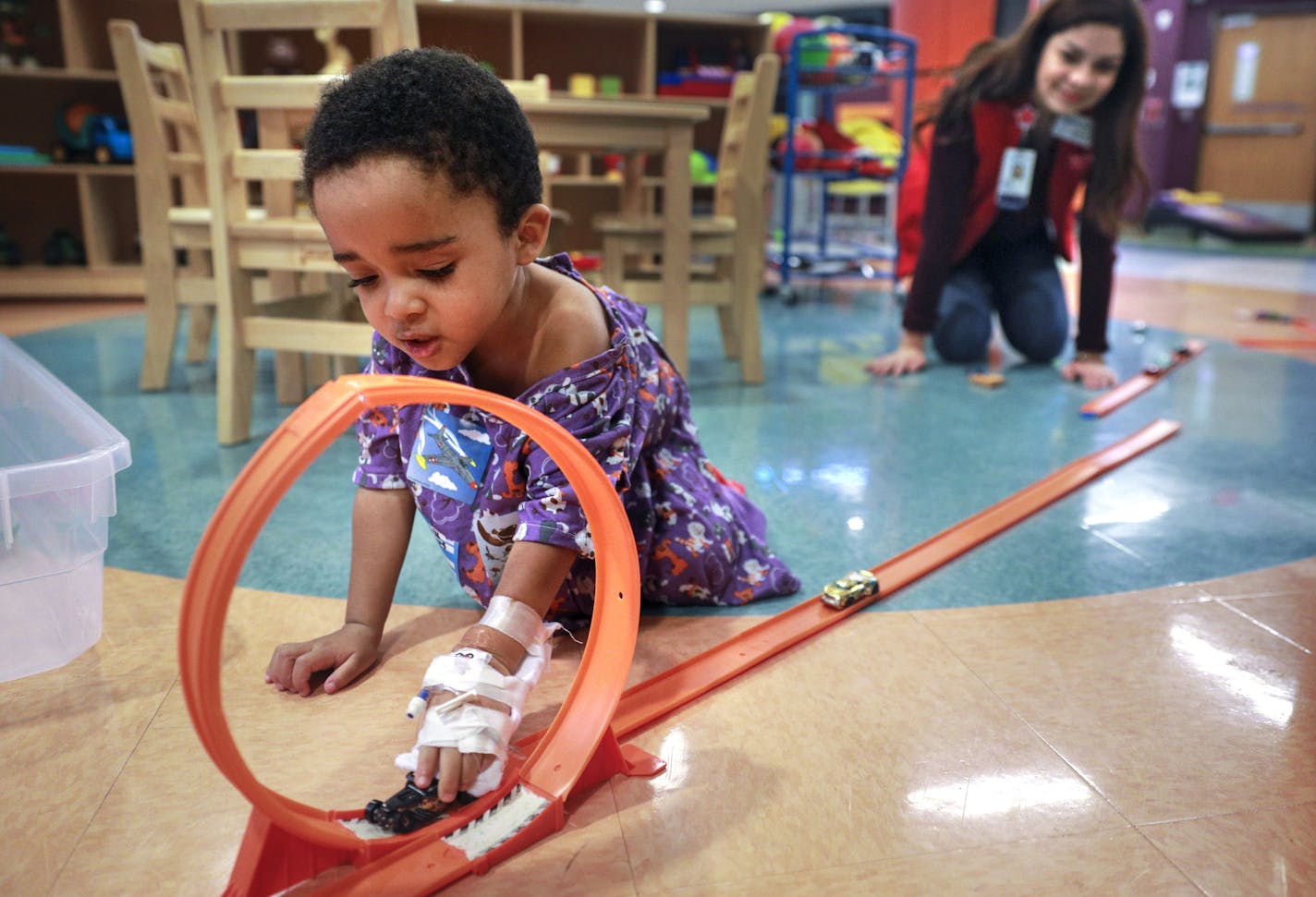 Child Life volunteer Yesica Mercado Munoz, 16, played with 2-year-old Damian Bridges, who was hospitalized for hypoglycemia at Children's Hospital in St. Paul.