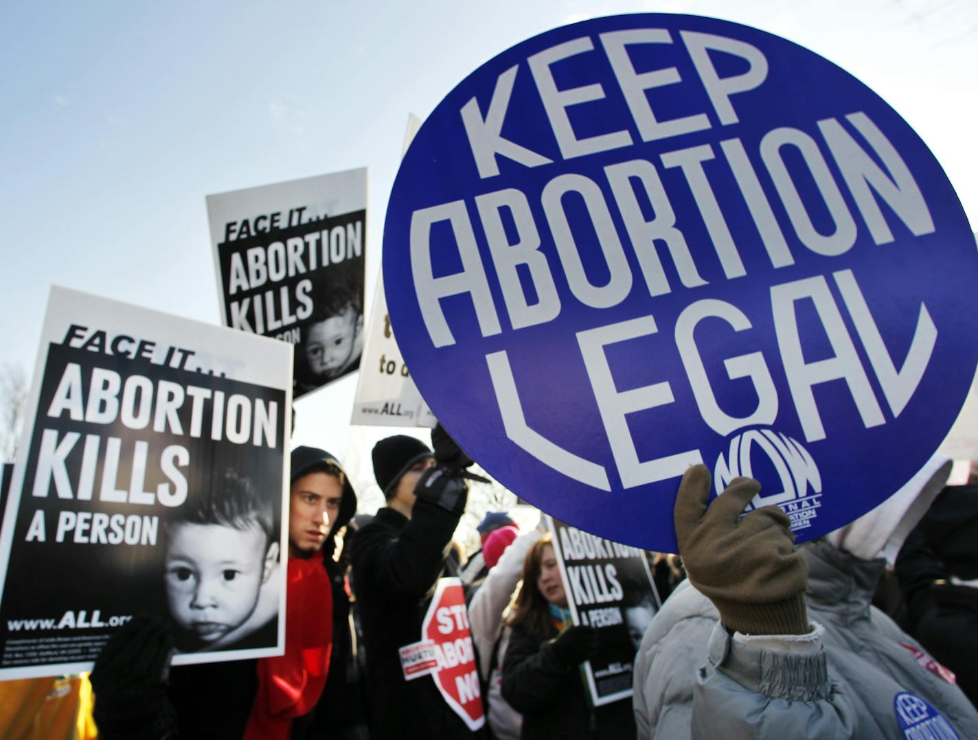 Anti-abortion and abortion activists stand side by side in front of the U.S. Supreme Court, in Washington, Monday, Jan. 24, 2011, during a rally against Roe v. Wade on the anniversary of the U.S. Supreme Court decision. (AP Photo/Manuel Balce Ceneta)