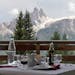 Alpine panorama over lunch at a mountain hut, along a trail above the town of Cortina, in the Dolomites, Northern Italy.