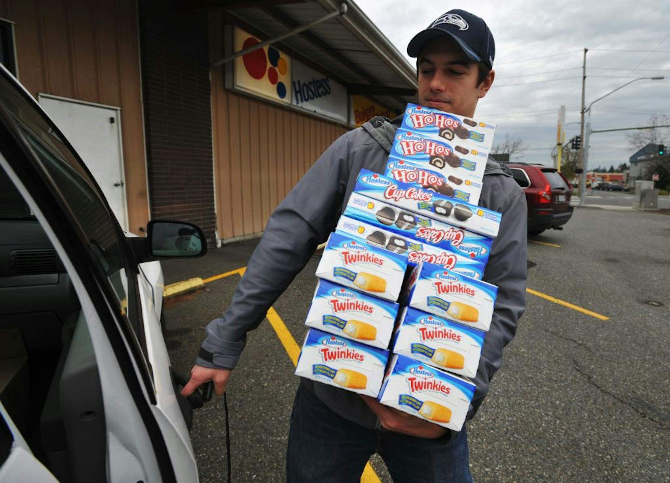 Andy Wagar loads Twinkies, Ho-Hos and Cup Cakes into a van outside the Wonder Bakery Thrift Shop in Bellingham, Wash., Friday, Nov. 16, 2012, after Hostess Brands Inc. said it would shutter is operations after years of struggling with management turmoil, rising labor costs and the ever-changing tastes of Americans even as its pantry of sugary cakes seemed suspended in time.