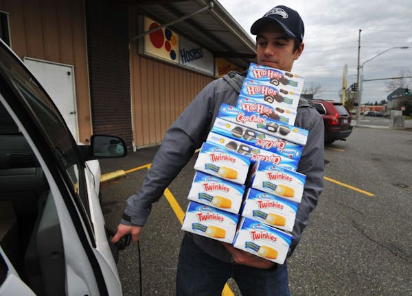 Andy Wagar loads Twinkies, Ho-Hos and Cup Cakes into a van outside the Wonder Bakery Thrift Shop in Bellingham, Wash., Friday, Nov. 16, 2012, after Ho