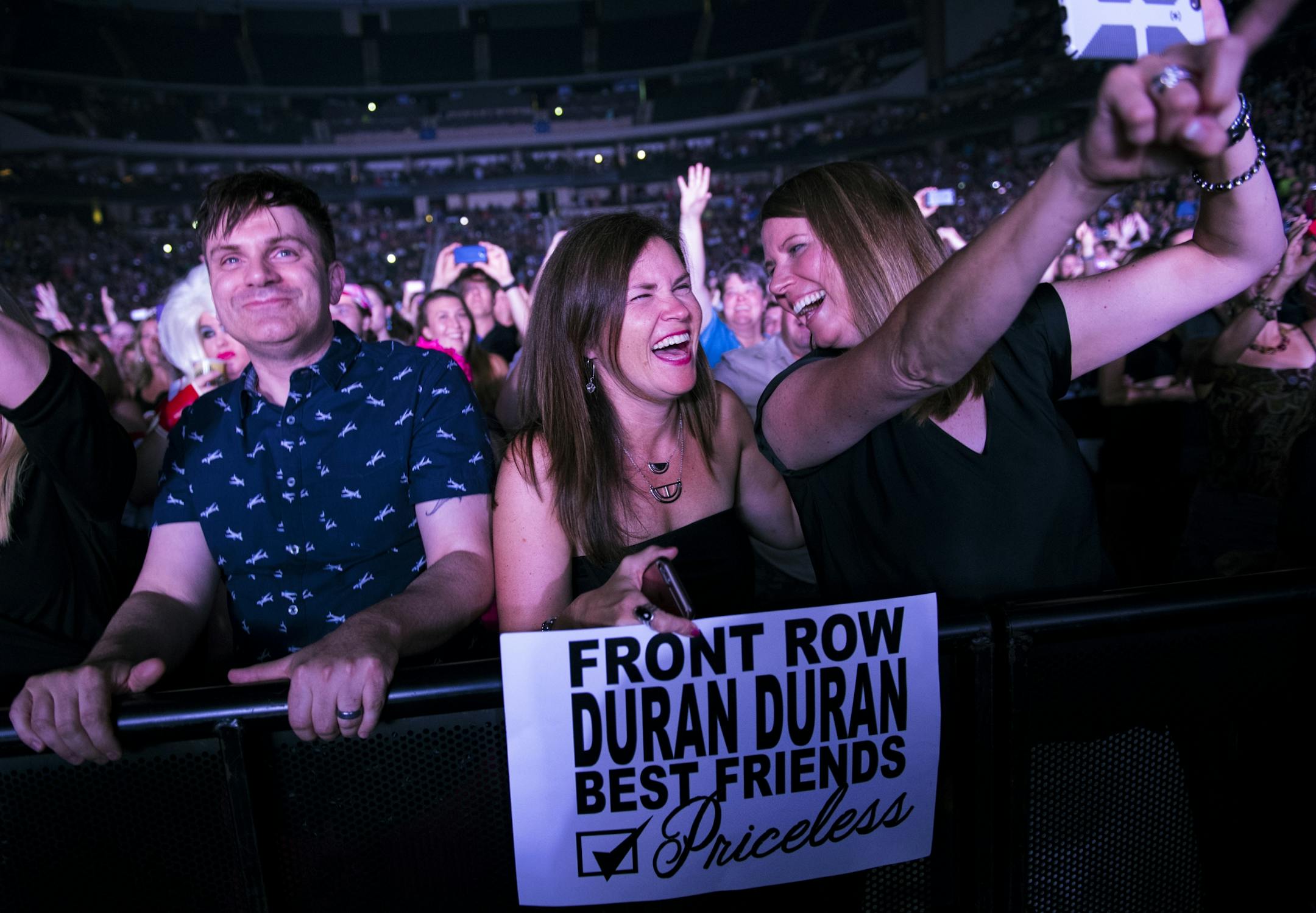 Sandi Missen, center, and Schelly Somenske sang along as Duran Duran performed at the Xcel Energy Center on Saturday night. "For 32 years we've been waiting to be in the front row," Somenske explained. Missen's husband got the duo front-row tickets to the concert for Christmas.