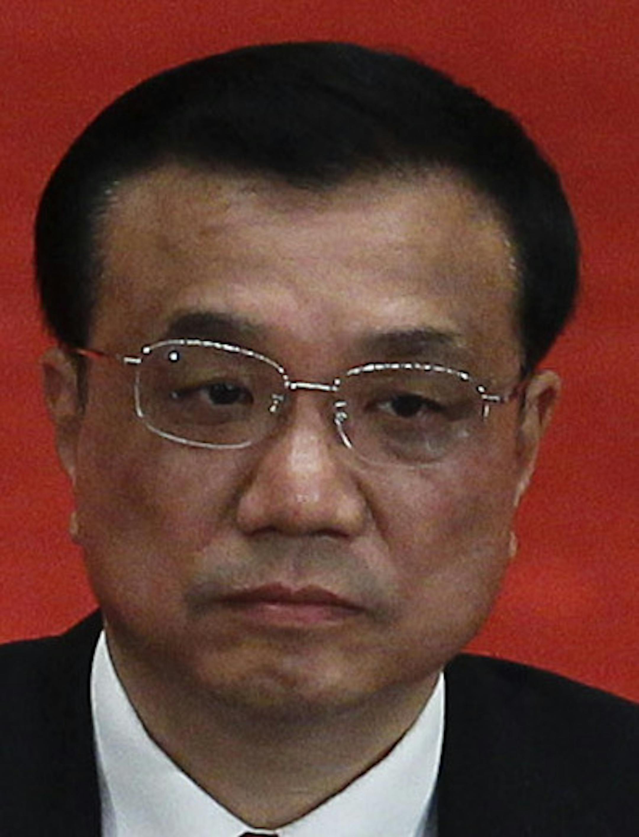 FILE - In this May 4, 2012 file photo, Zhou Yongkang, left, then Chinese Communist Party Politburo Standing Committee member in charge of security, and Li Keqiang, right, then Chinese vice premier and now premier, attend a conference to celebrate the 90th anniversary of the founding of Chinese Communist Youth League at the Great Hall of the People in Beijing. An influential Hong Kong newspaper reported Friday, Aug. 30, 2013, that Chinaís top leadership has agreed to start a corruption inves