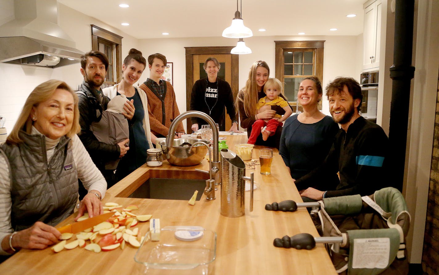 The newly-renovated kitchen is a social hub as well as multiple meal preparation stations for the 10 family members who share it. Left to right: Carol Baudler, Jonathan Blaseg, holding baby Hattie, Rachel Baudler Blaseg, Henry Kent, Will Baudler, Nathalie Kent holding Otto Blaseg, Tina Lee and Josh Kent.