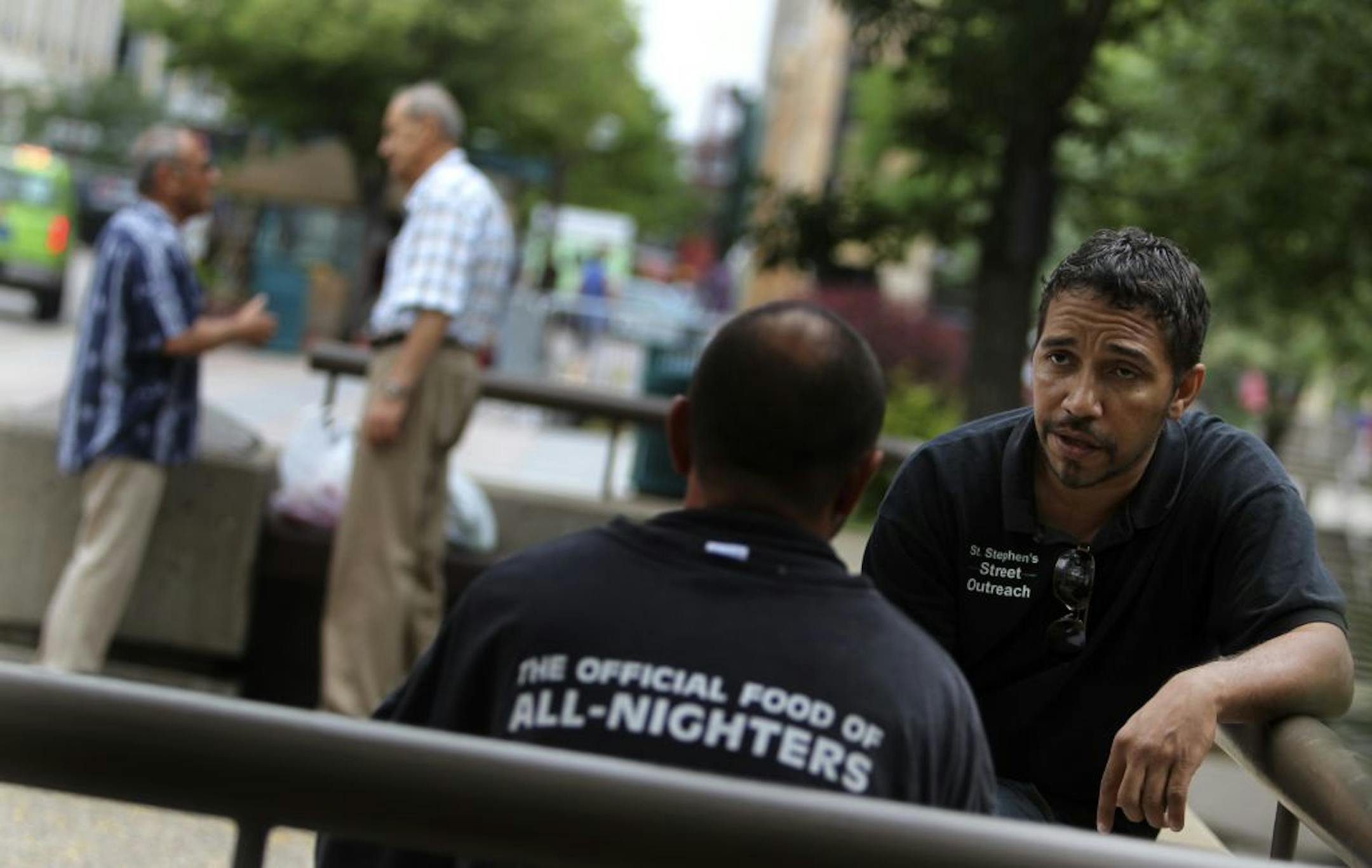 Desenclos, right, met in downtown Minneapolis with a homeless man named Bryan who didn't want his full name used or face shown. The people who live on the streets of Minneapolis often fall victim to violence, police and advocates say.