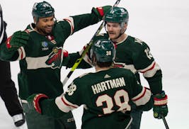 Wild players Ryan Reaves, Sam Steel (13) and Ryan Hartman celebrated after Reaves scored in Sunday’s victory over the Capitals.