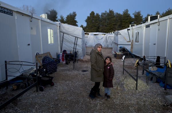 A pregnant Syrian refugee with her daughter at the refugee camp of Ritsona in Greece.
