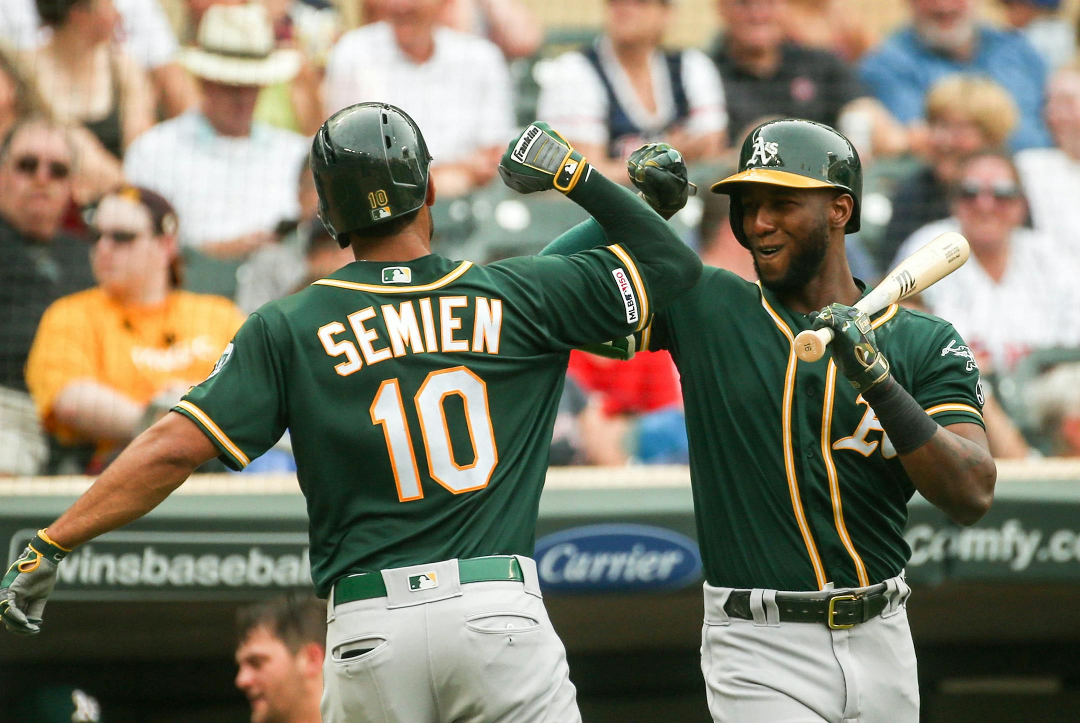 Oakland Athletics shortstop Marcus Semien (10) gets congratulated at home after hitting a home run in the first inning. ] NICOLE NERI • nicole.neri@startribune.com BACKGROUND INFORMATION: Minnesota Twins play Oakland Athletics at Target Field Friday, July 19, 2019.