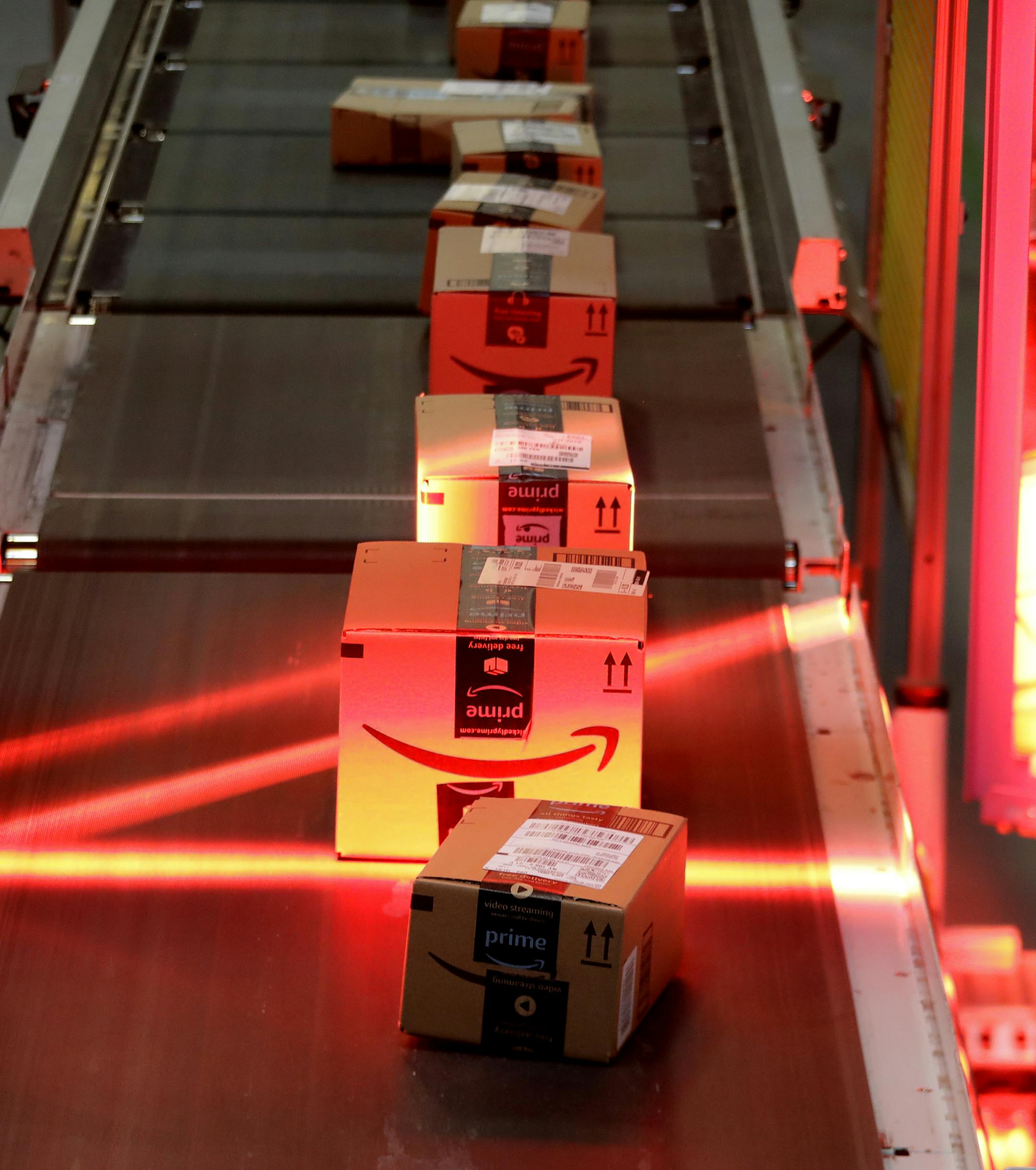 Packages riding on a belt are scanned at the Amazon Fulfillment center in Robbinsville Township, N.J., Tuesday, Aug. 1, 2017. Amazon held a nation-wide job fair at its warehouses on Aug. 2. (AP Photo/Julio Cortez) ORG XMIT: NJJC20