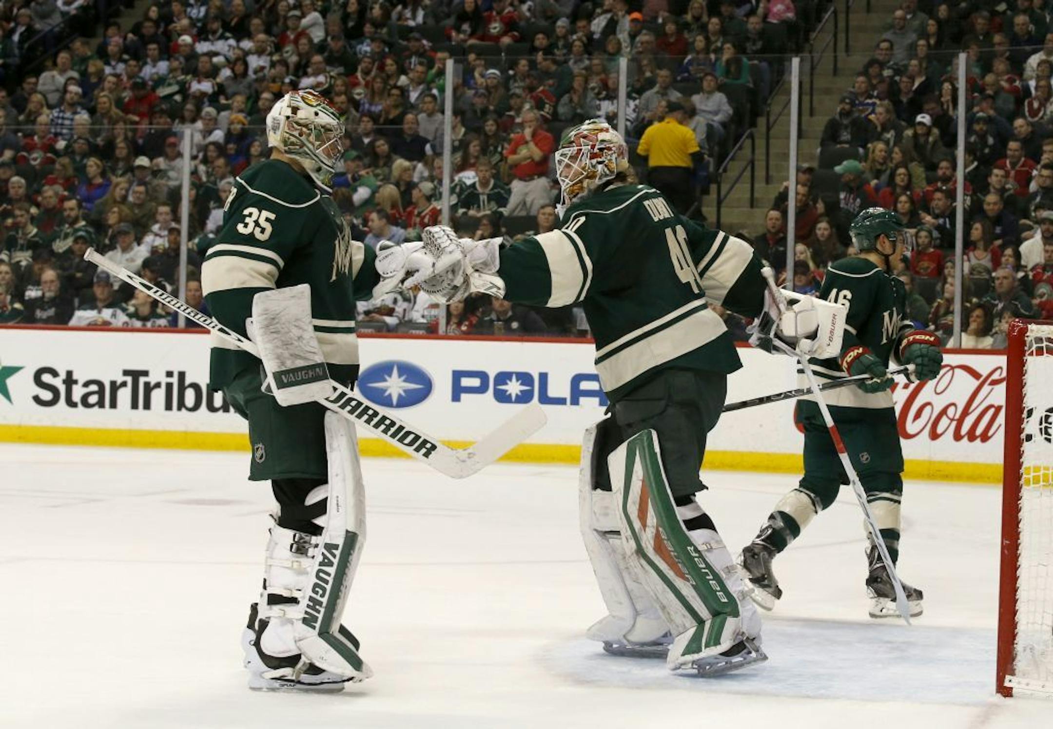 Minnesota Wild goalie Darcy Kuemper (35) replaces Devan Dubnyk (40) during the second period of an NHL hockey game against the St. Louis Blues in St. Paul, Minn., Sunday, March 6, 2016.