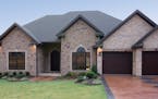 French country-stye rambler features a series of gable peaks and an arch-topped window. for plan011517