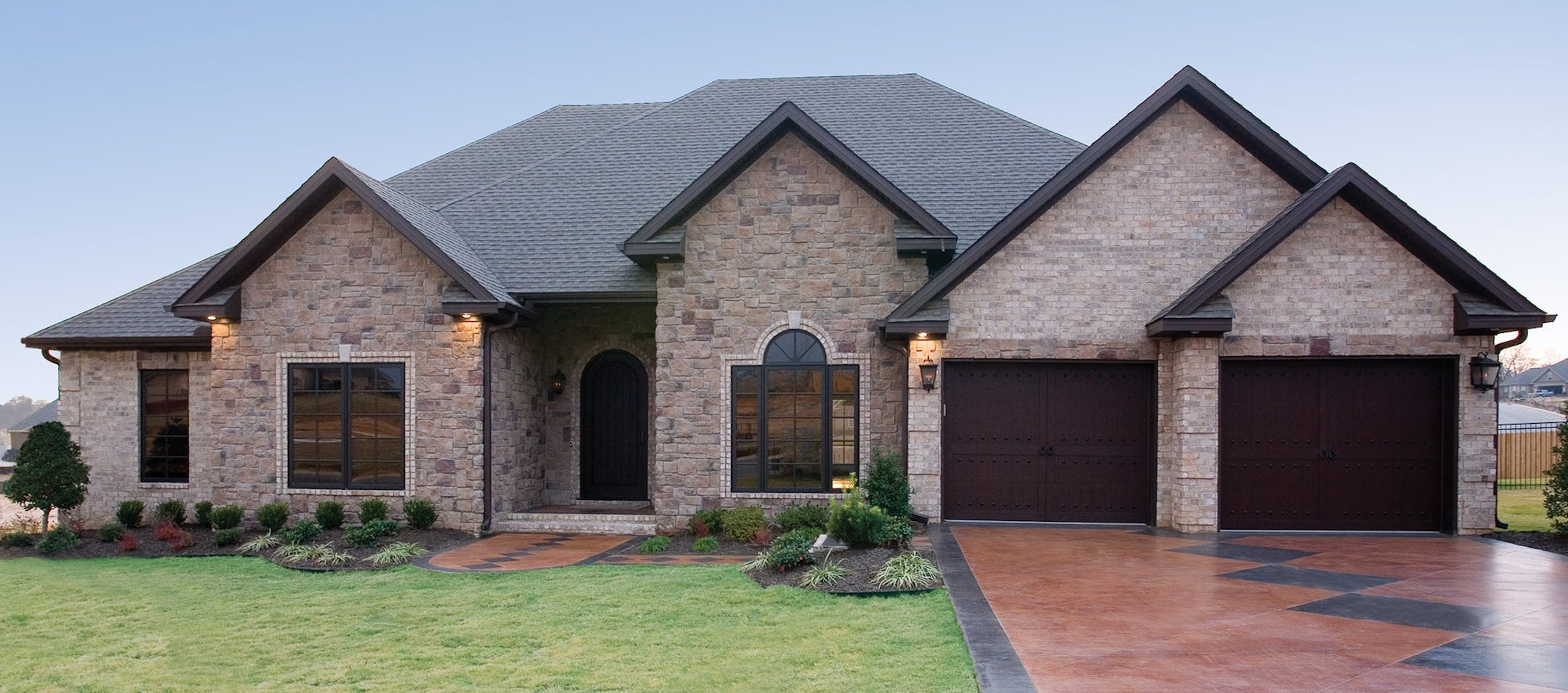 French country-stye rambler features a series of gable peaks and an arch-topped window. for plan011517