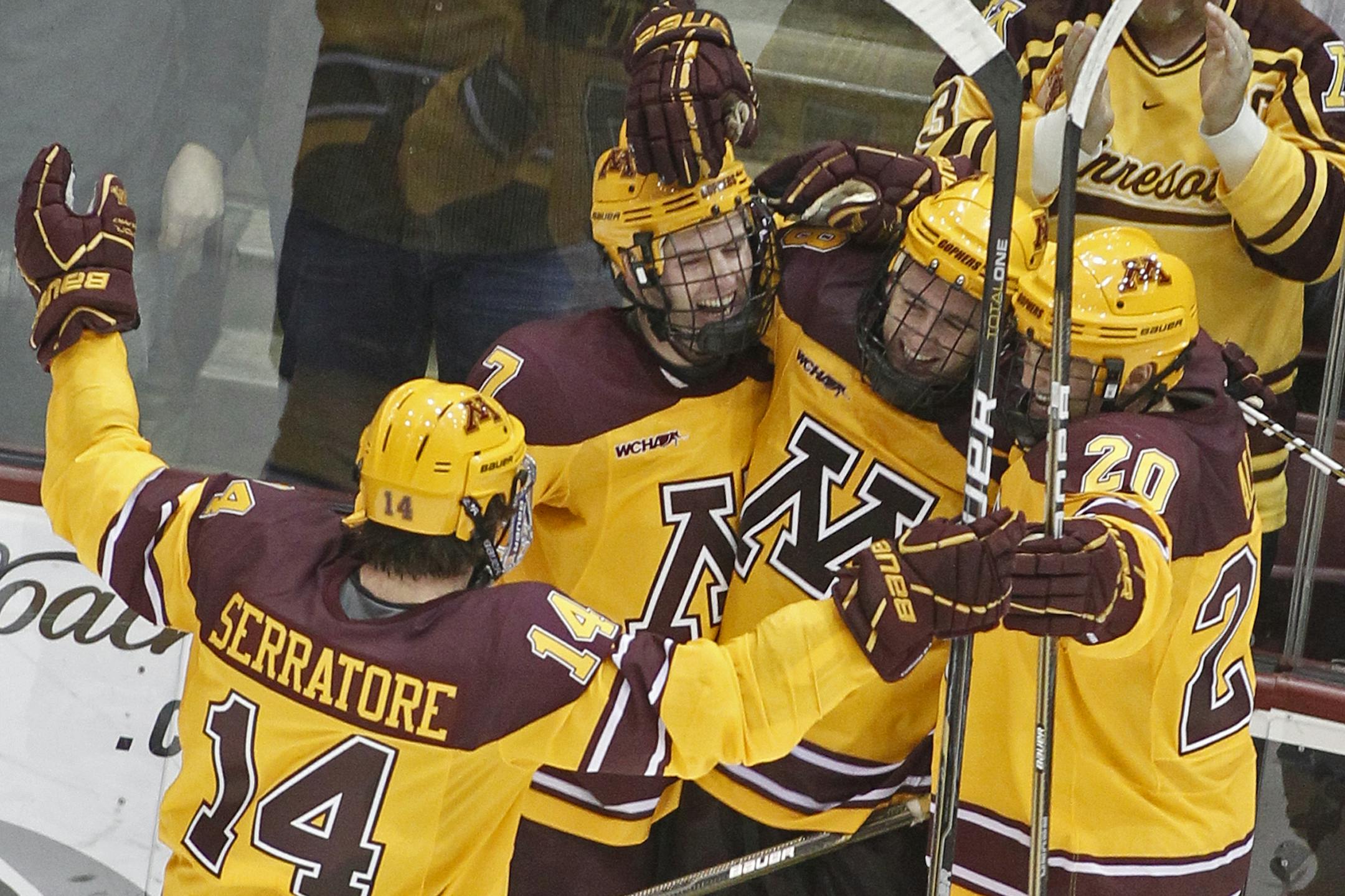 The Gophers' Tom Serratore, Patrick White (7) and Mark Alt (20) rushed to congratulate Nick Larson, second from right, on his second-period goal against Michigan on Sunday at Mariucci Arena.