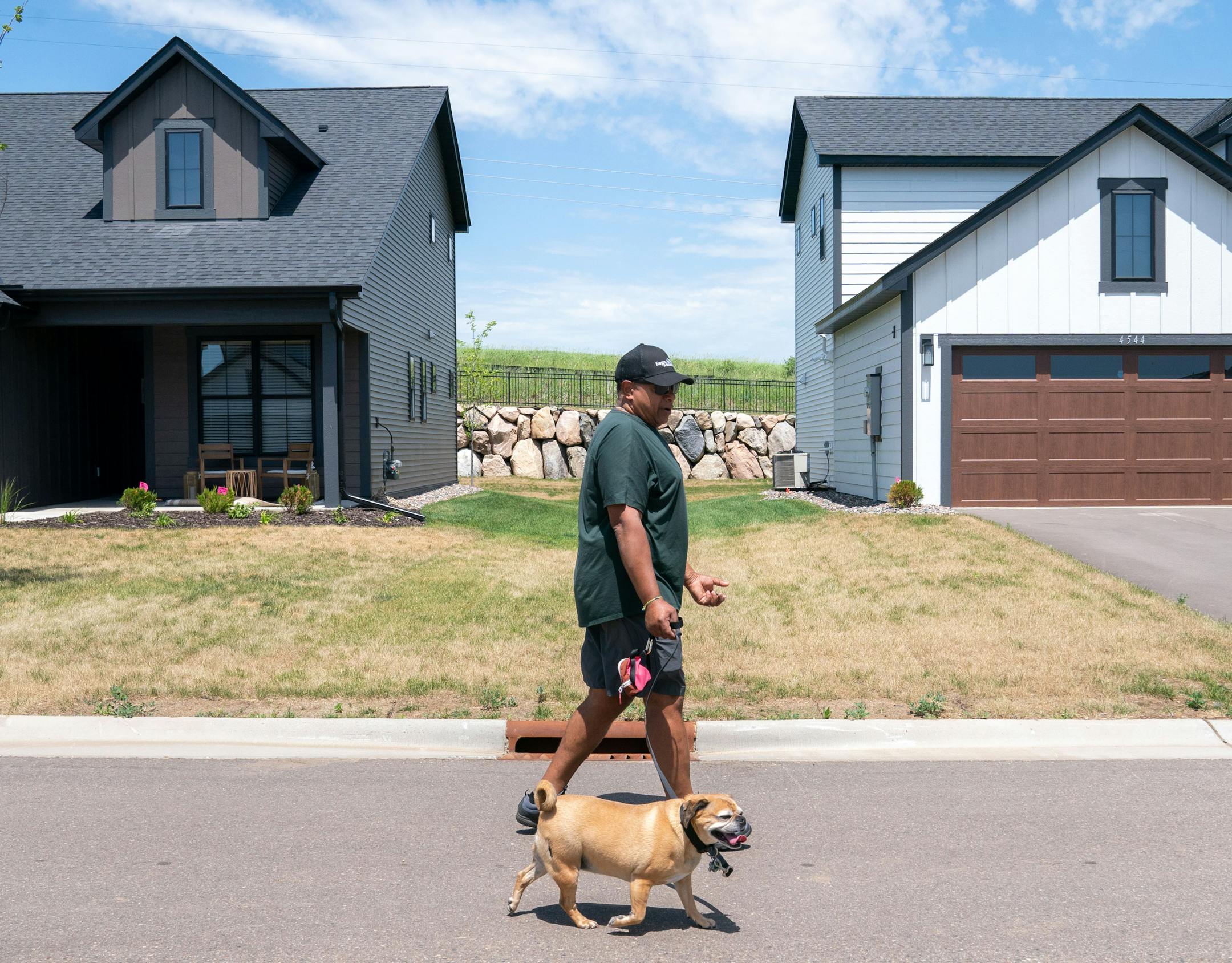 Michael England, who moved in about a month ago, walked his dog in the Canvas at Woodbury.