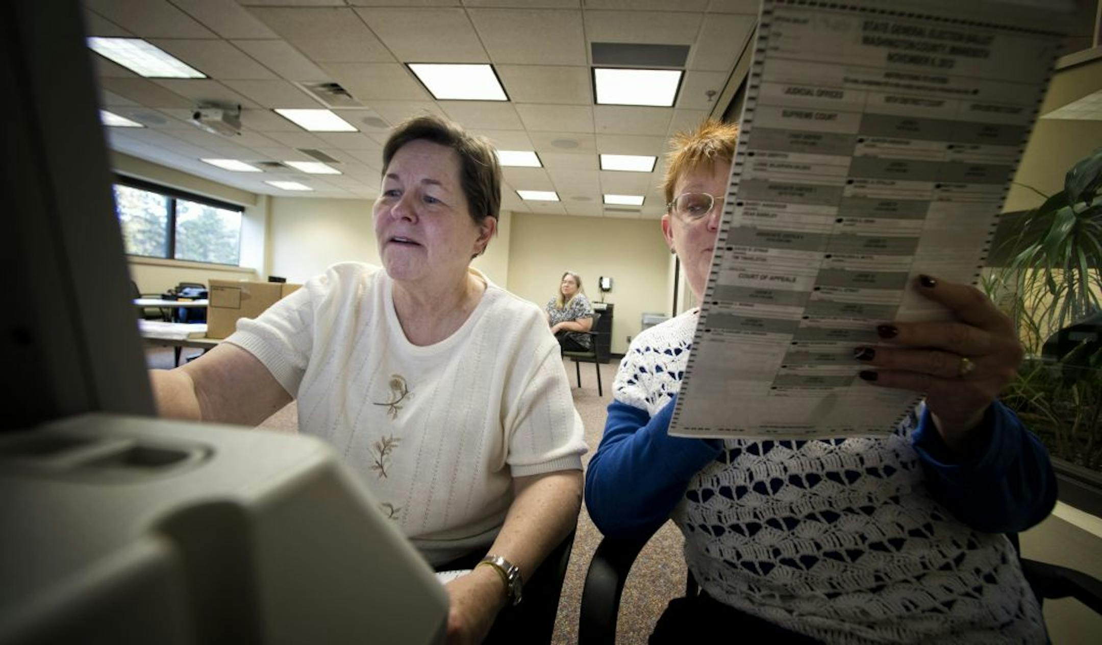 Washington County election judges Pam Nielsen, left, and Janet Jacobsen, right, ran test ballots from a voting machine that assists people with disabilities in voting, Tuesday, October 23, 2012 in Stillwater.