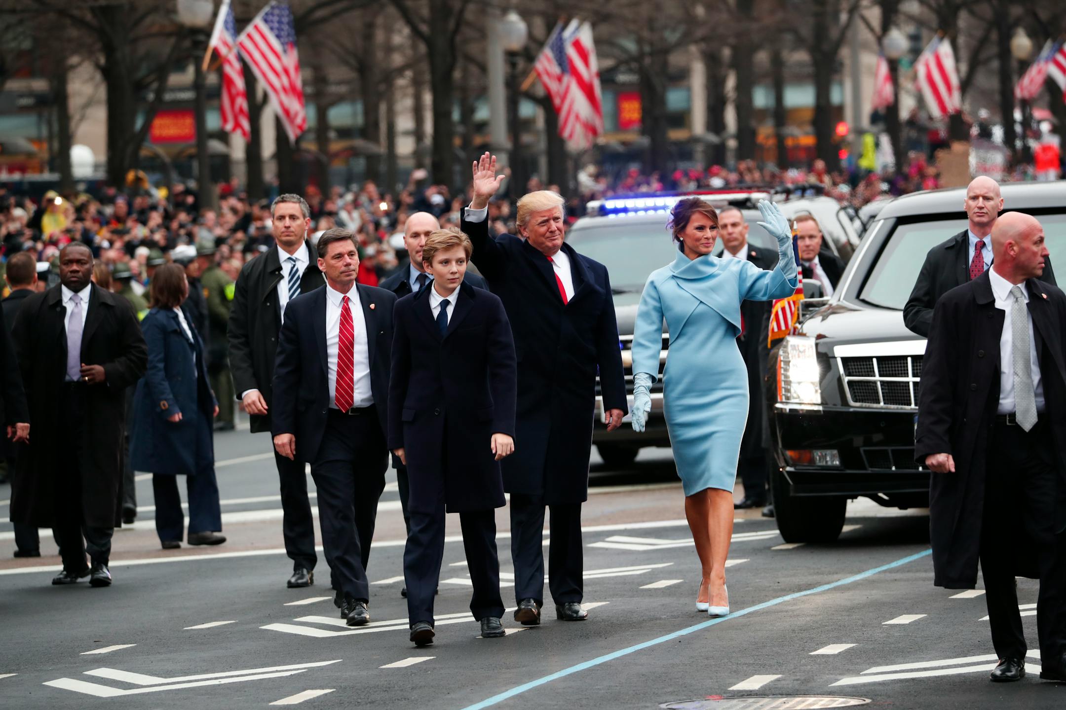 President Donald Trump and first lady Melania Trump walk briefly with their son Barron on the inauguration parade route in Washington, Jan. 20, 2017. (Doug Mills/The New York Times)