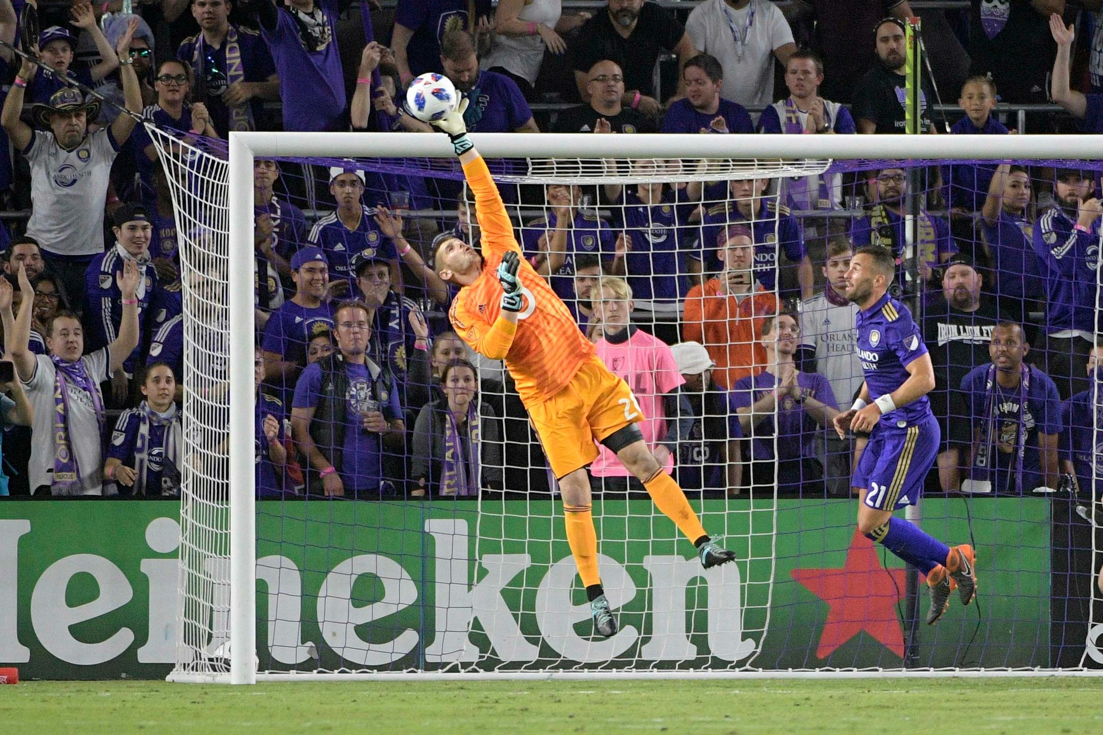 Minnesota United goalkeeper Matt Lampson (28) blocks a shot in front of Orlando City midfielder Scott Sutter (21) during the second half of an MLS soccer game Saturday, March 10, 2018, in Orlando, Fla. Minnesota won 2-1. (Phelan M. Ebenhack for the Star-Tribune) ORG XMIT: OTKMINN105