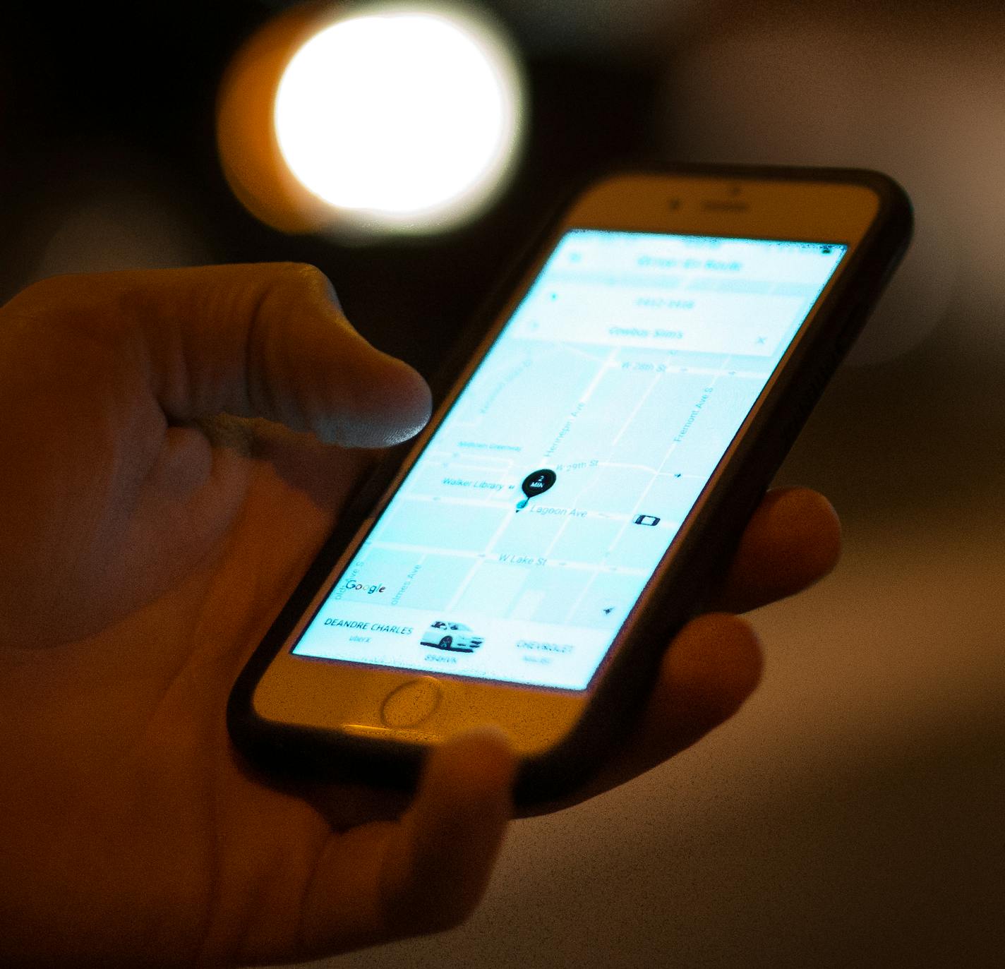 An Uber customer checked the status of his ride on his phone while waiting at the intersection of Lagoon Avenue and Hennepin Avenue late Saturday night. ] (AARON LAVINSKY/STAR TRIBUNE) aaron.lavinsky@startribune.com Uber and Lyft drivers picked up bar patrons at Lagoon Avenue and Hennepin Avenue in Minneapolis on Saturday, August 6, 2016.