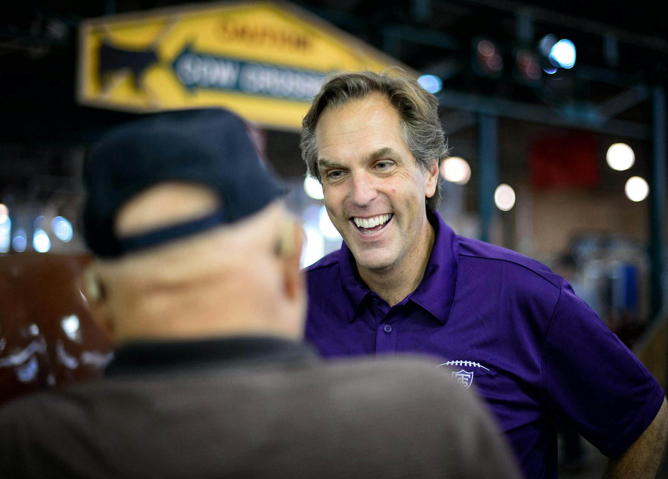 GOP Senate candidate Mike McFadden laughed with Larry and Evy Walters of Brooklyn Park in the State Fair Cattle Barn in Aug. 2014.