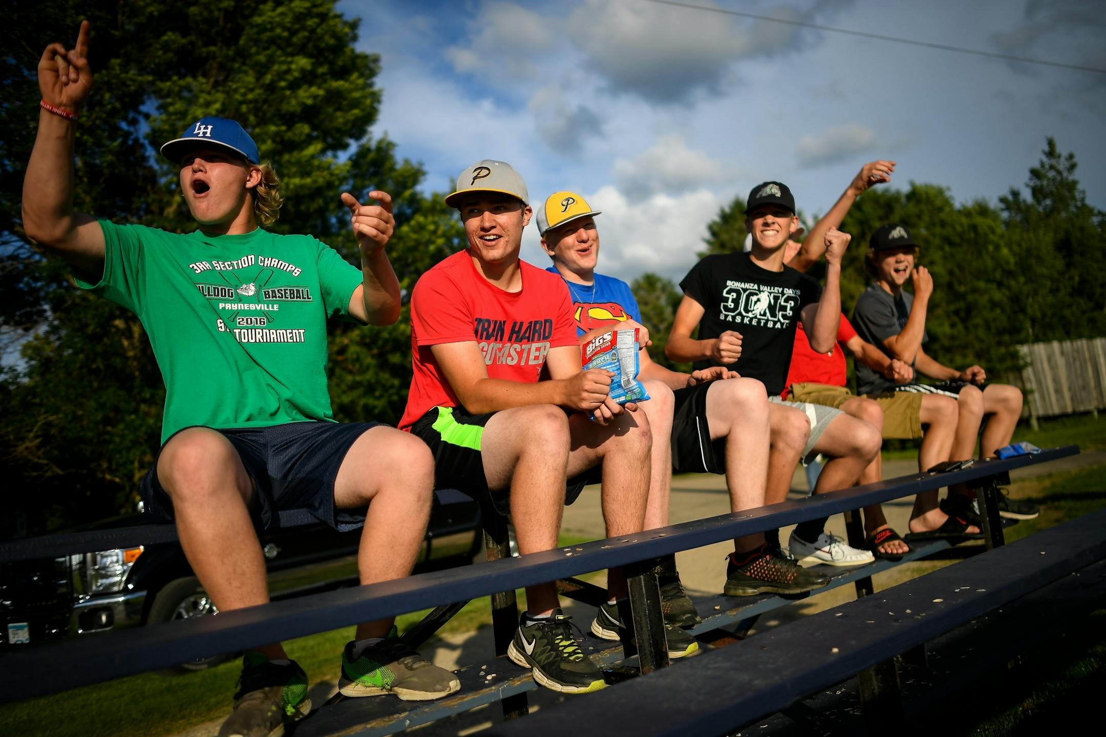 A group of high school friends from Paynesville who play in the County Line League watched the home run derby between the County Line League and the Stearns County League on Friday, June 30, 2017 in Elrosa, Minn.