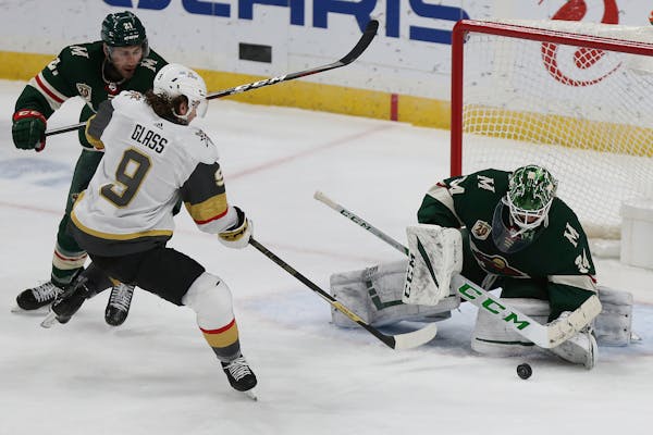 Minnesota Wild's goalie Kaapo Kahkonen (34) blocks a shot-attempt by Vegas Golden Knights' Cody Glass (9) in the third period of an NHL hockey game Mo