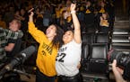Ava Blarark, left, and Suazanna Huffins celebrate during a watch party after Iowa defeated UConn on Friday in the women's Final Four semifinals.