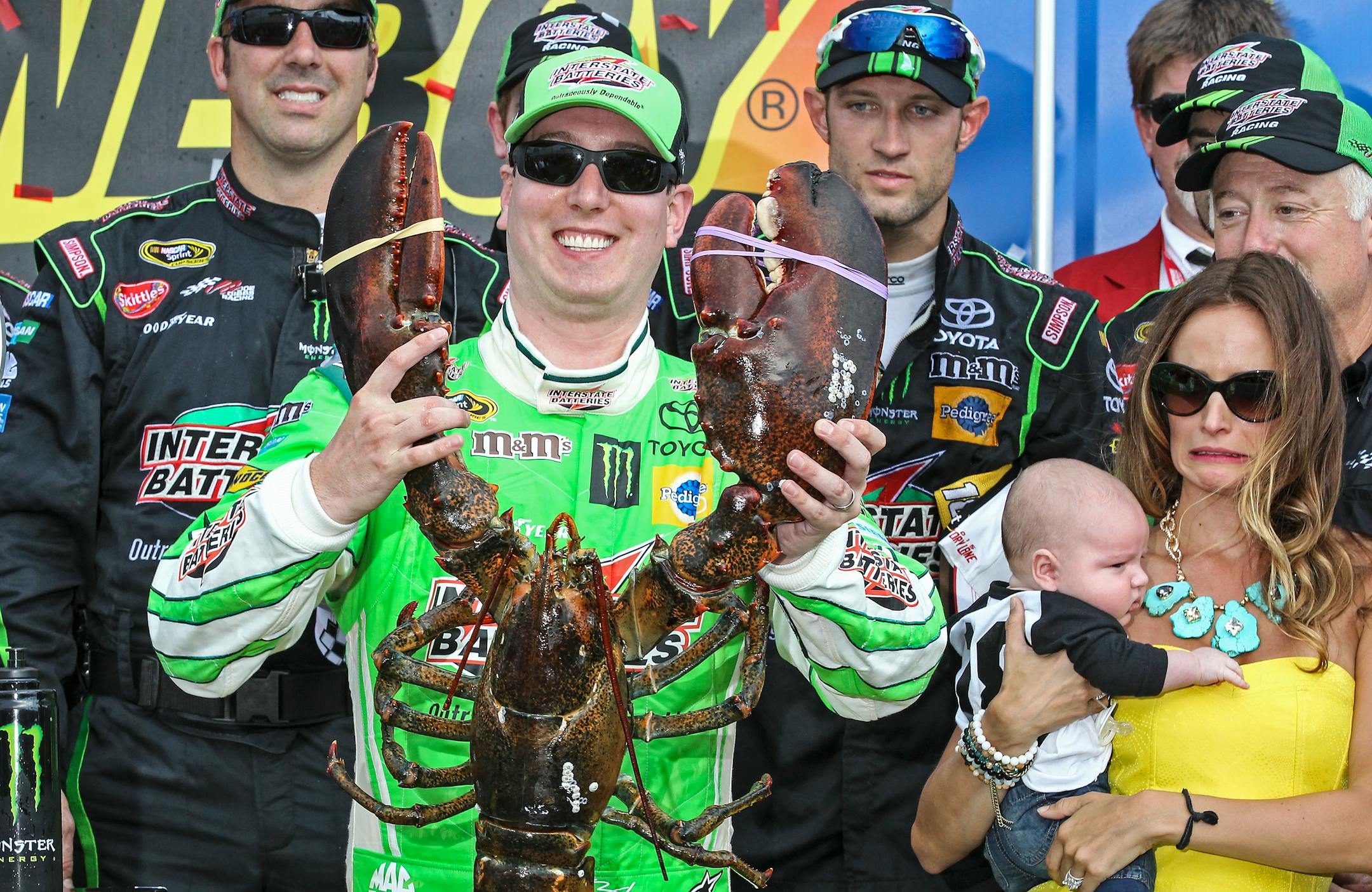 Kyle Busch held the Loudon lobster trophy in Victory Lane, as his wife, Samantha (right, holding son Brexton) looked on, after winning the NASCAR Sprint Cup series race at New Hampshire Motor Speedway on Sunday.