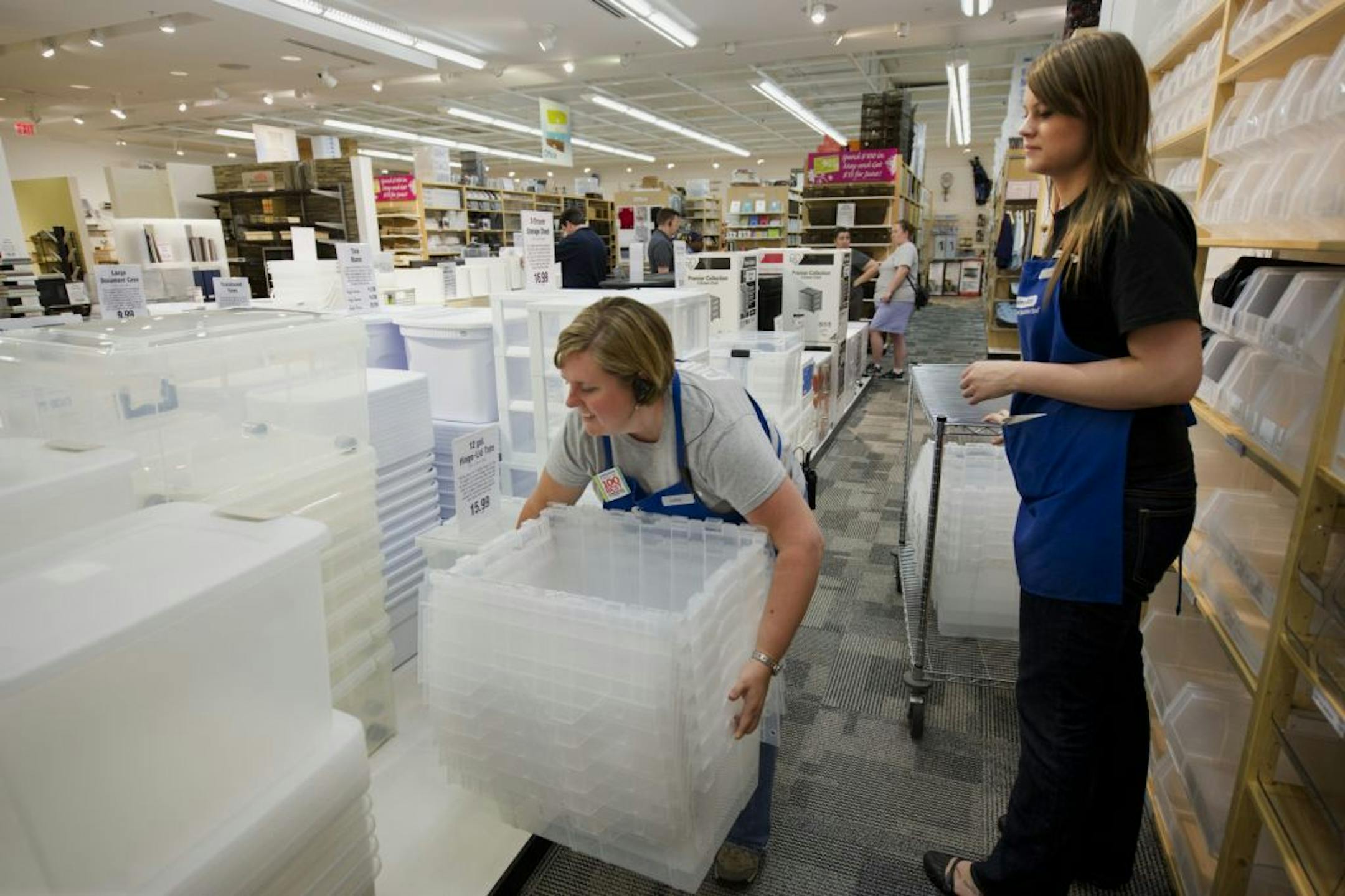 The Container Store manager, Chris Redding, and employee Anne Szczepaniak, re-stock storage containers. Forbes magazine has named the Container Store one of the 100 best places to work in the country for 12 years in a row.