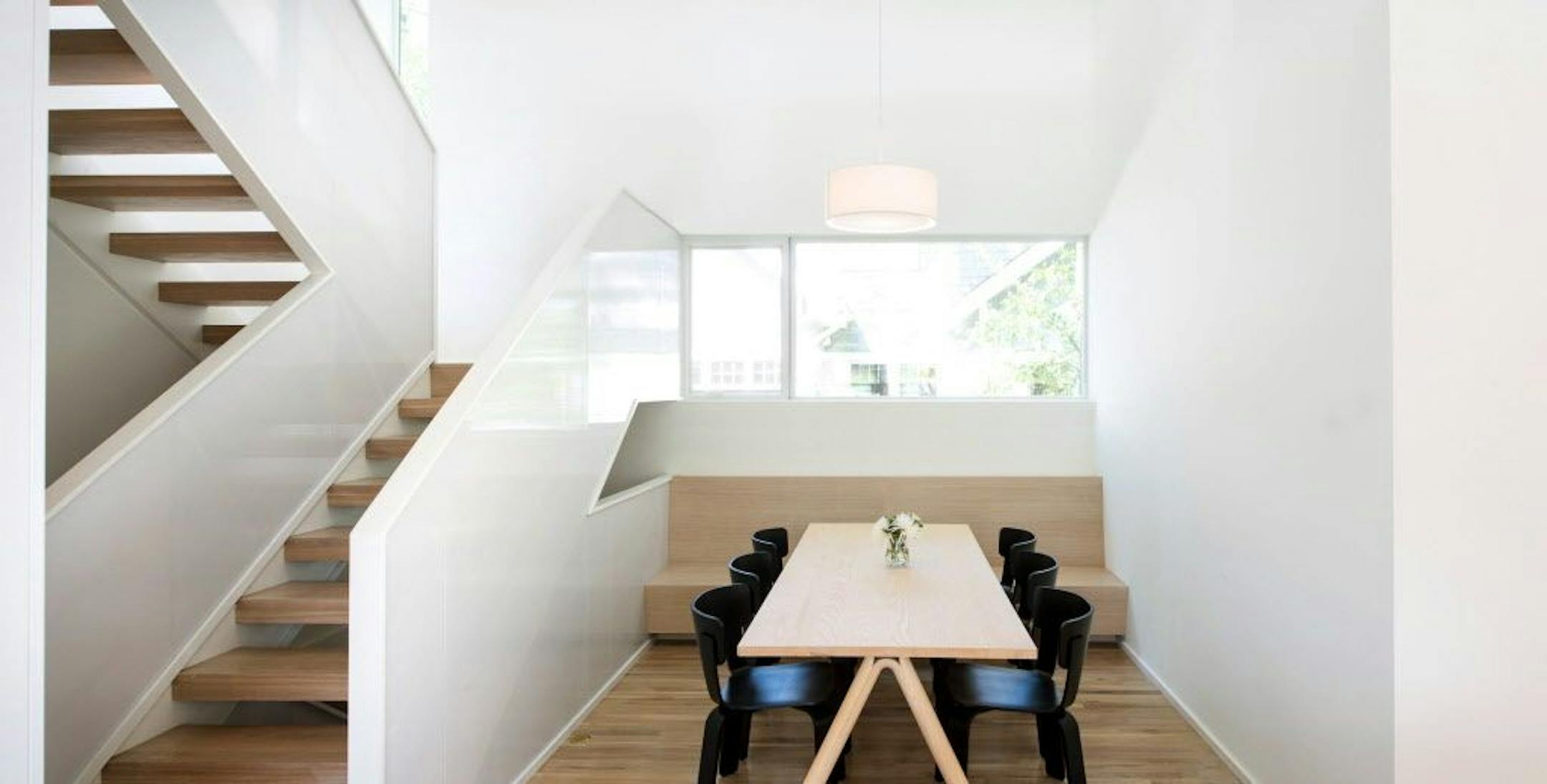 The open staircase and dining area, which also has a built-in bench.