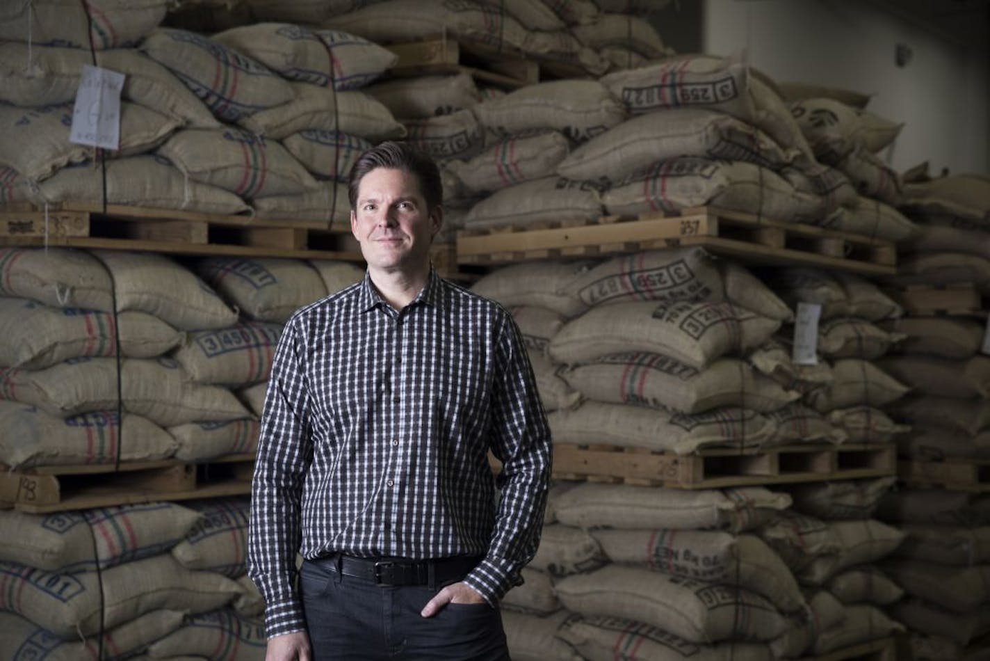 New Caribou President John Butcher, in front of bags of coffee in Brooklyn Center, has a bold vision for the company.