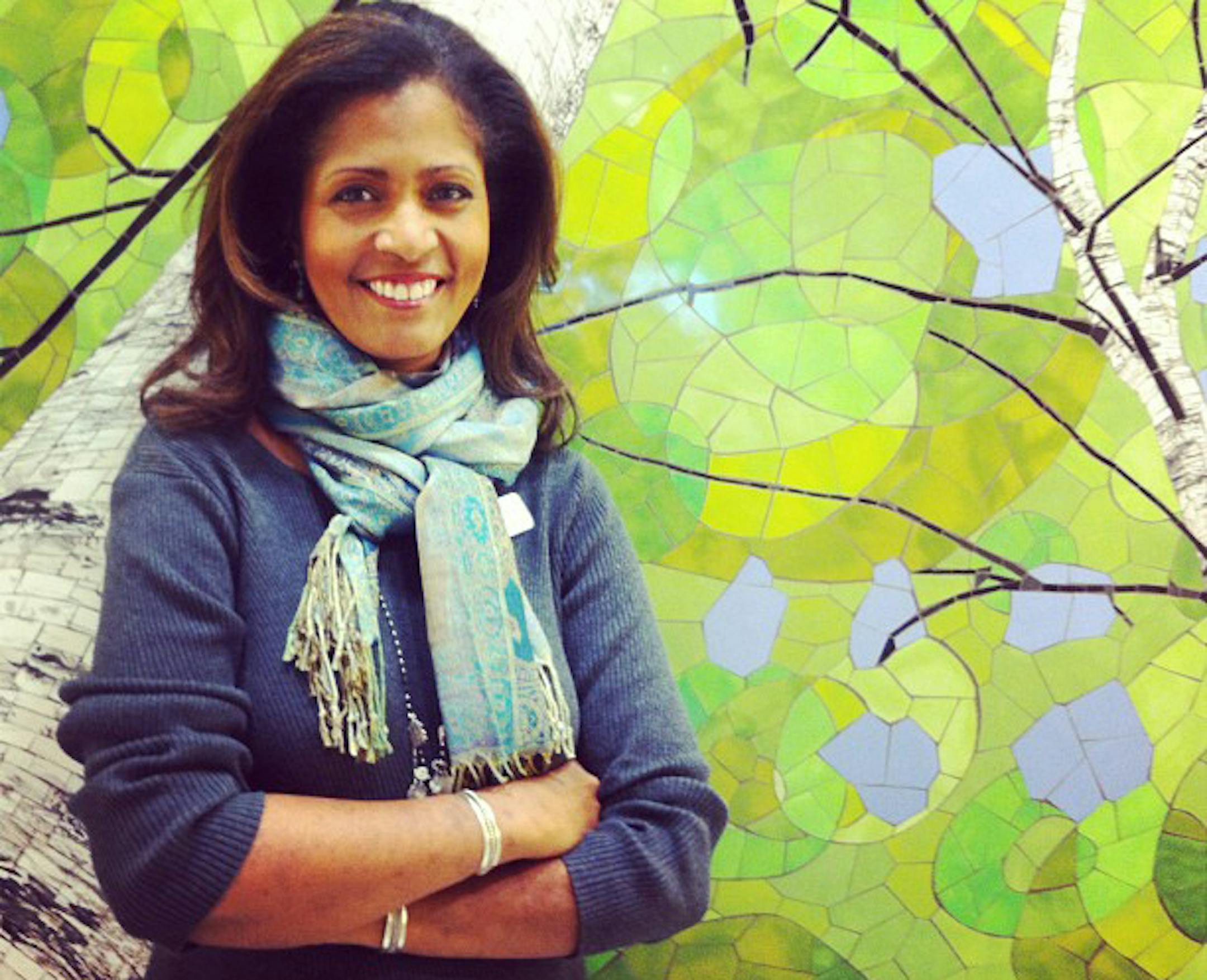 Robyne Robinson stands in front of a birch-tree mural by Minnesota artist Barbara Keith in one of the newly renovated bathrooms at the airport.