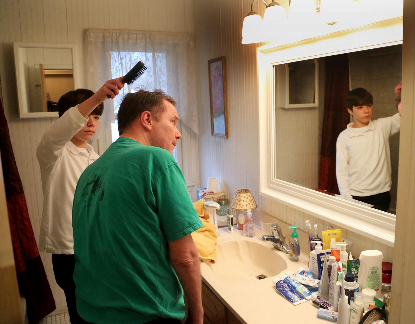 Kieran White brushed his father Bob's hair after helping him shower.