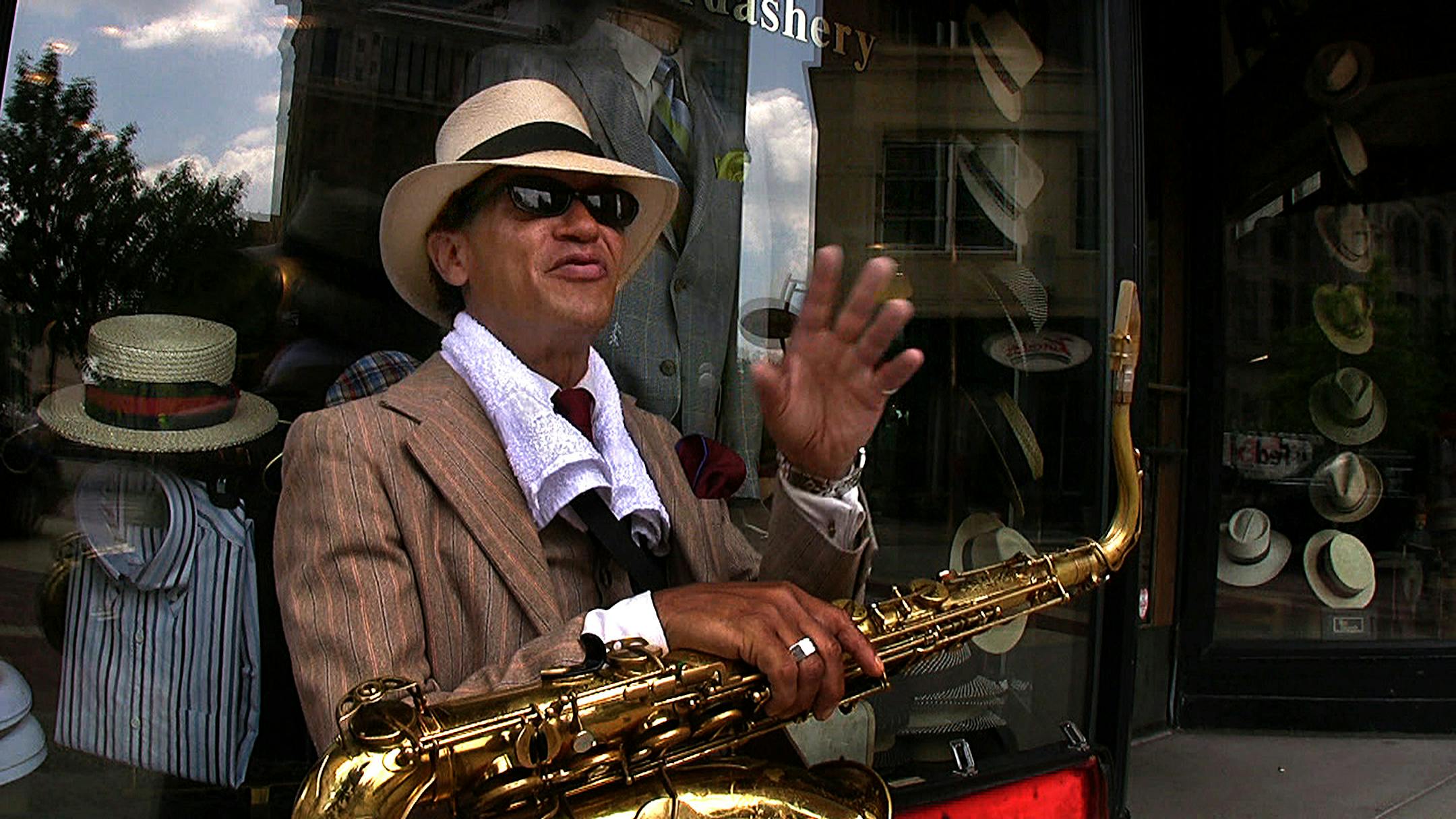 Jimmy Wallace filled the air with the sweet sound of his saxophone music during the lunch hour in downtown St. Paul, outside Heimie's Haberdashery where he also works. Wallace is an Air Force veteran who entertains passersby almost every day.