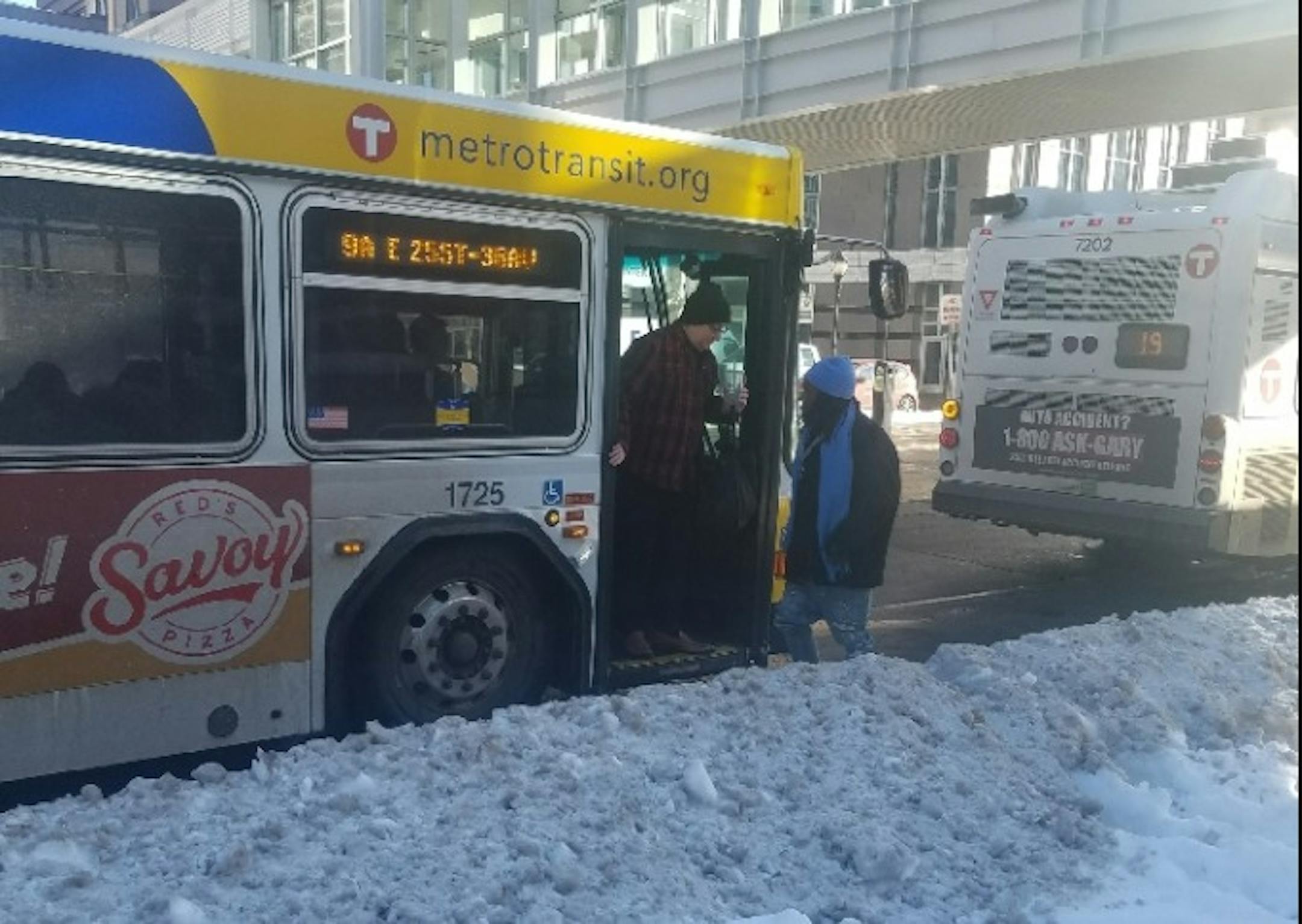 Passengers getting off a Route 9 bus at 8th Street and 3rd Avenue S. in downtown Minneapolis navigated a snowbound bus stop on Friday.