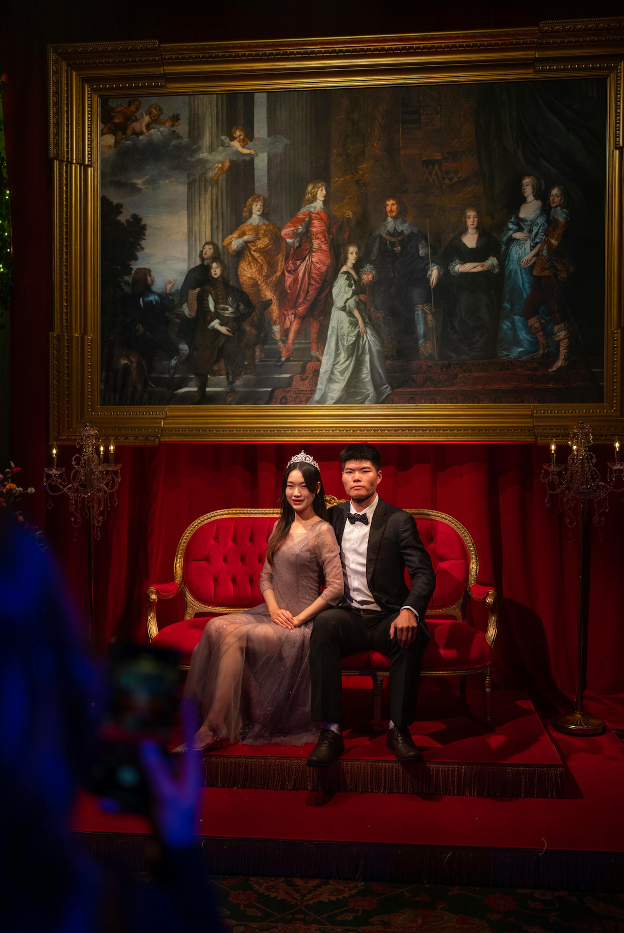 A couple posed for a photo on opening night of The Queen's Ball: A Bridgerton Experience.