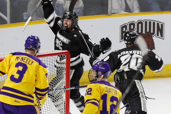 Providence's Scott Conway (10) celebrates the goal by teammate Kasper Björkqvist (20) as Minnesota State's Jack McNeely (3) and Max Coatta (12) look 