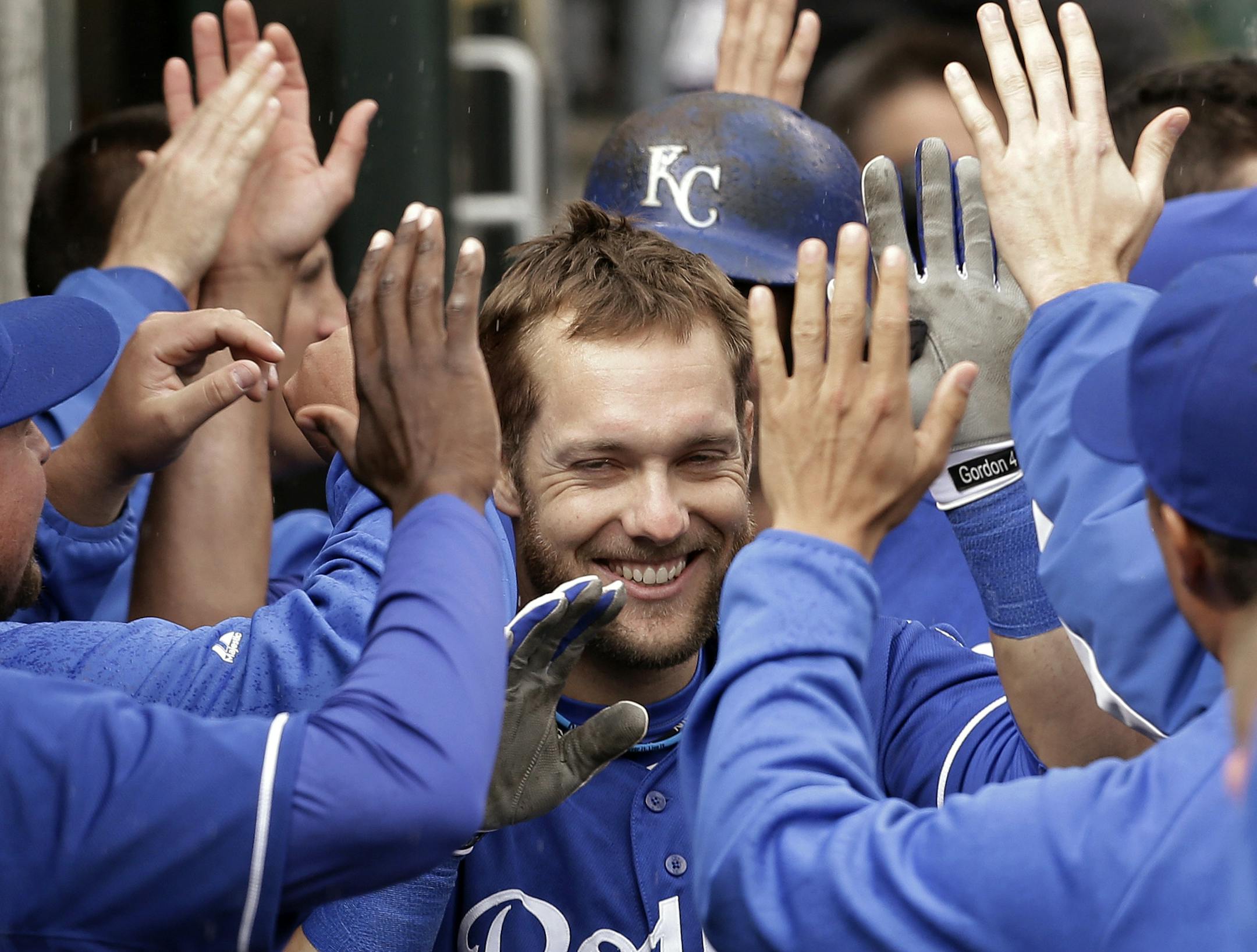 Kansas City Royals' Alex Gordon celebrates his grand slam against the Detroit Tigers in the 10th inning of a baseball game in Detroit, Thursday, April 25, 2013. (AP Photo/Paul Sancya) ORG XMIT: MIN2013042516242762